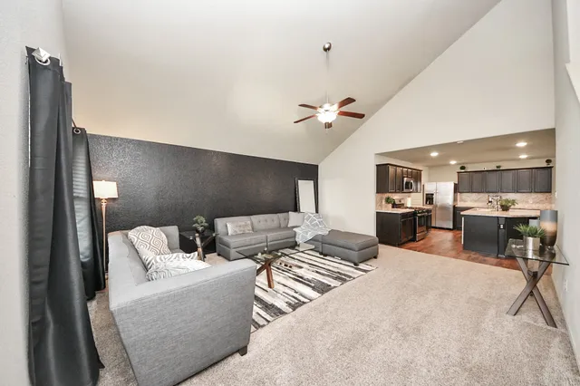 a living room with furniture and kitchen view