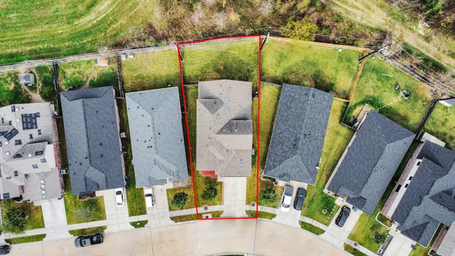 an aerial view of residential house with outdoor space and parking