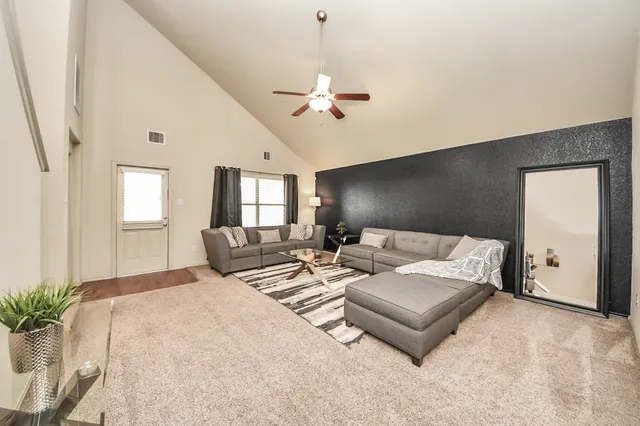 a living room with furniture potted plant and a window