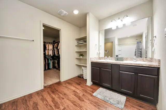 a spacious bathroom with a sink a vanity and a mirror