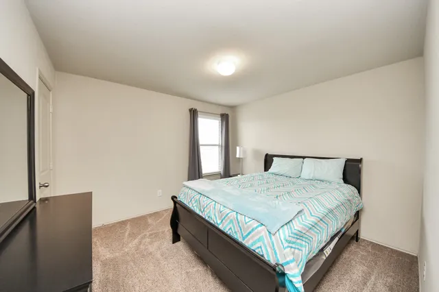 a bedroom with a bed and window