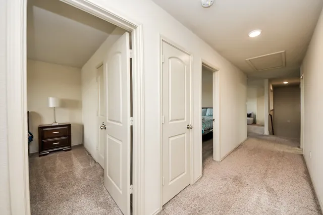 a view of a hallway with wooden shelves
