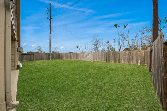 a view of a backyard with a fence