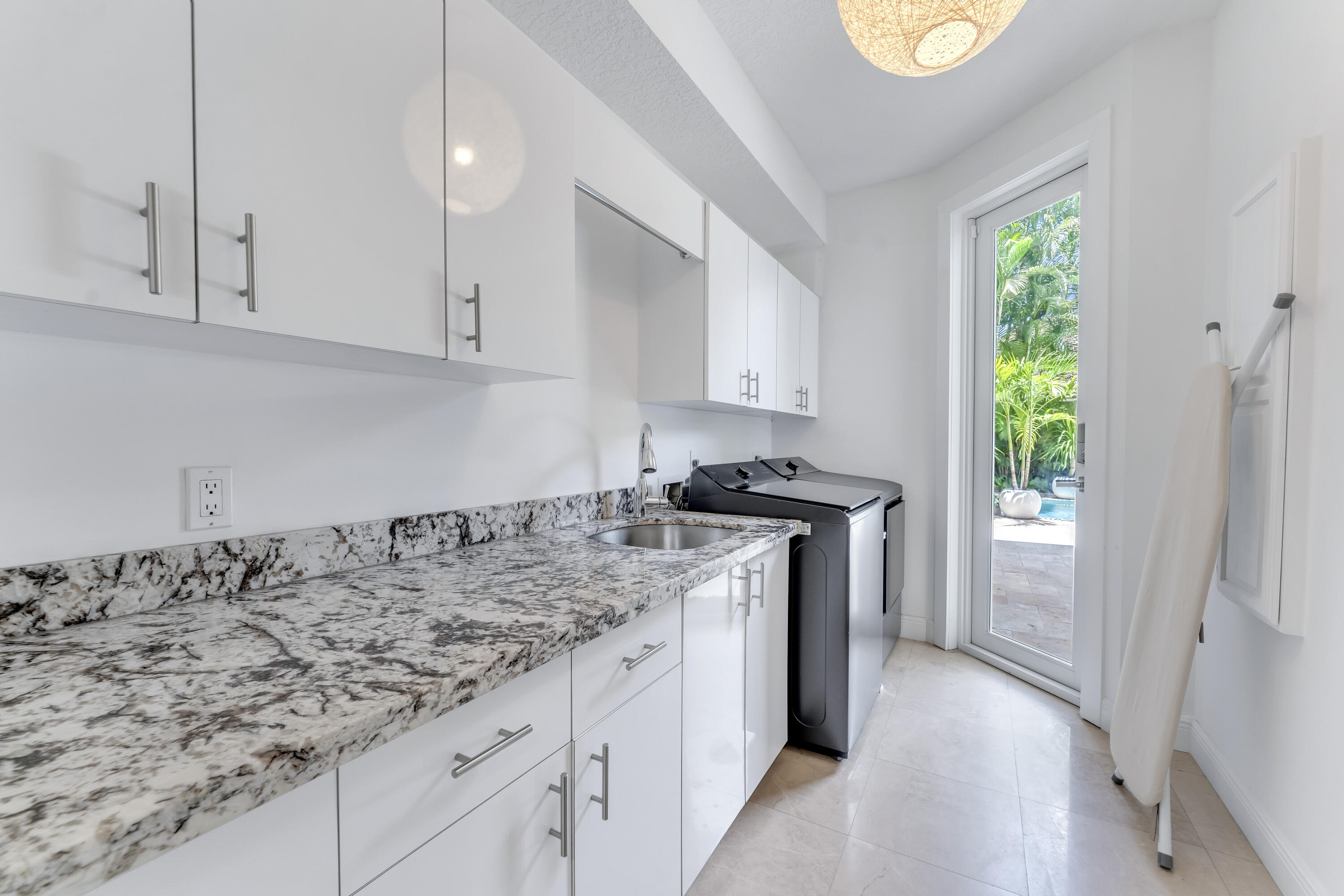 3156 Northwest 61st Street Boca Raton, FL 33496 - Photo 26 of 46 a kitchen that has a sink and a stove