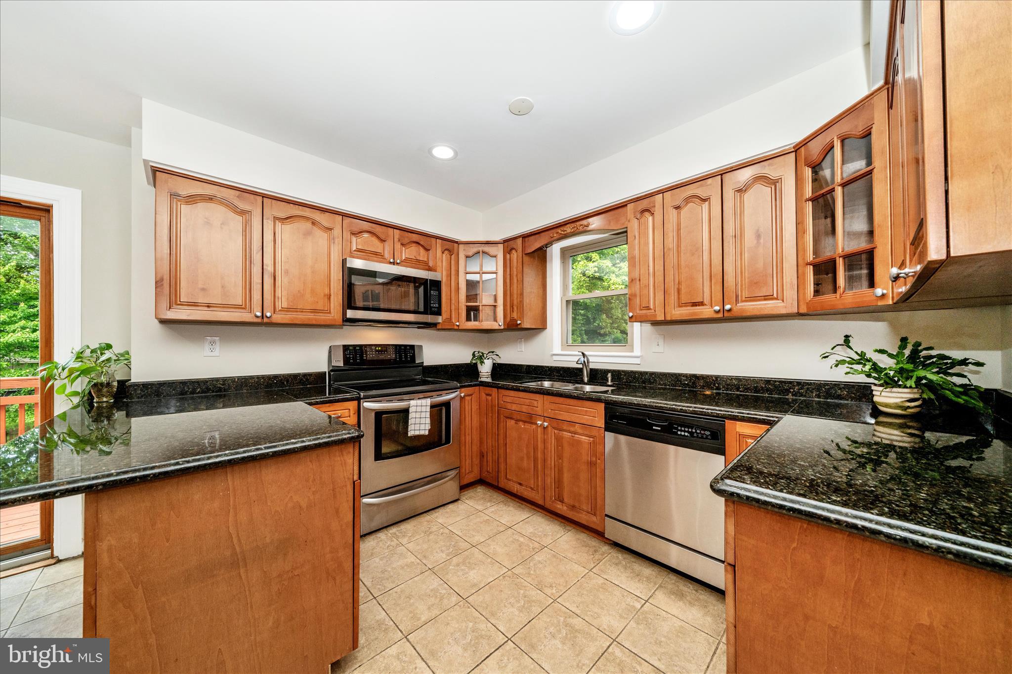 16000 Narrows Terrace Silver Spring, MD 20906 - Photo 15 of 54 a kitchen with stainless steel appliances granite countertop sink stove top oven and microwave