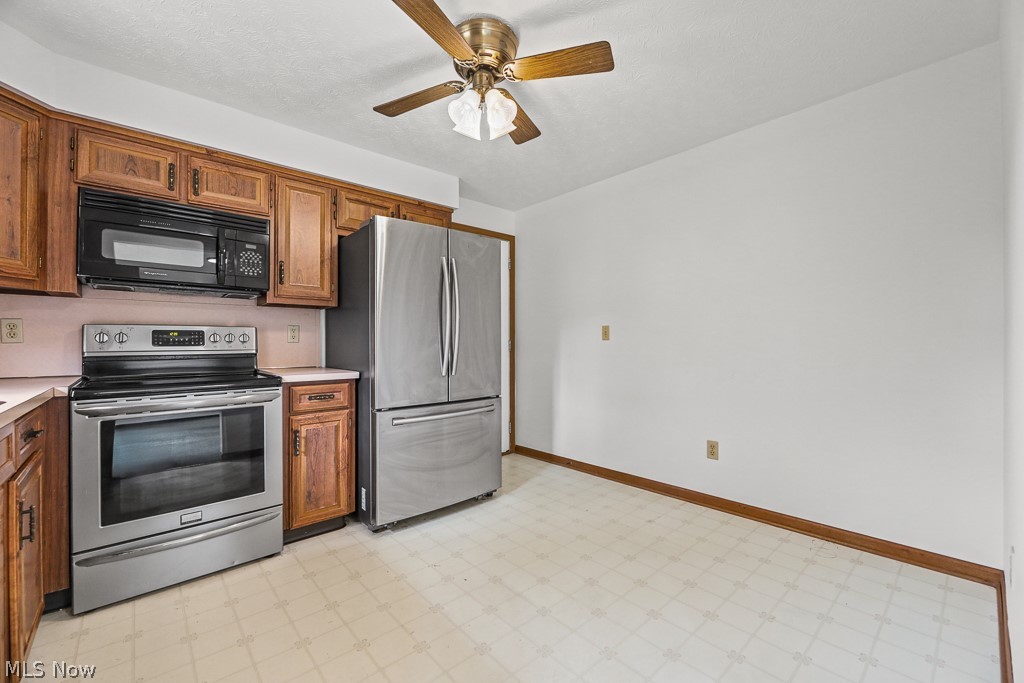2642 Blake Road Wadsworth, OH 44281 - Photo 15 of 46 Kitchen featuring wood cabinetry, stainless steel appliances, and a ceiling fan