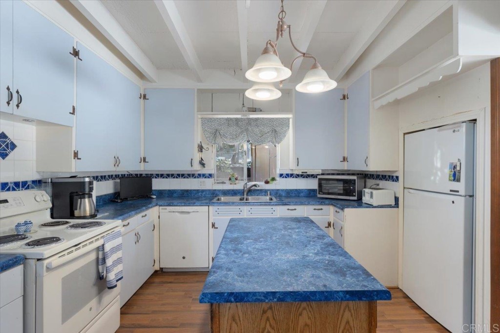 365 Eldorado Drive Escondido, CA 92025 - Photo 12 of 36 a kitchen with cabinets and wooden floor