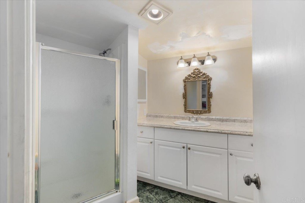 365 Eldorado Drive Escondido, CA 92025 - Photo 22 of 36 a bathroom with a granite countertop sink and a mirror