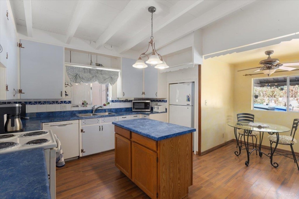 365 Eldorado Drive Escondido, CA 92025 - Photo 9 of 36 a kitchen with center island table and chairs