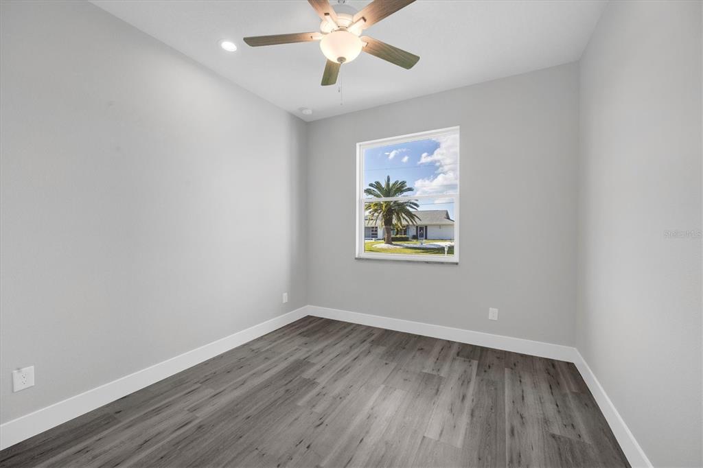 9 Bunker Place Rotonda West, FL 33947 - Photo 24 of 36 wooden floor in an empty room with a window