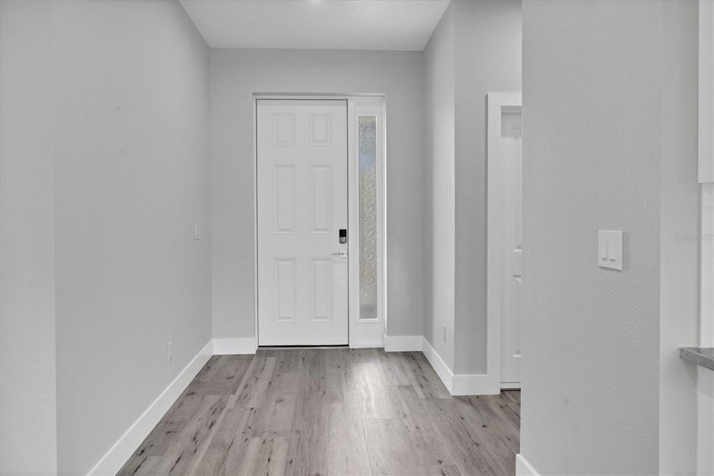 9 Bunker Place Rotonda West, FL 33947 - Photo 9 of 36 a view of a room with wooden floor and closet