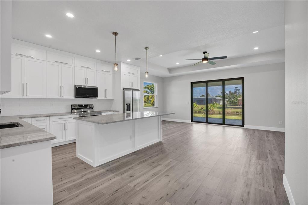 9 Bunker Place Rotonda West, FL 33947 - Photo 10 of 36 a view of kitchen with sink and wooden floor