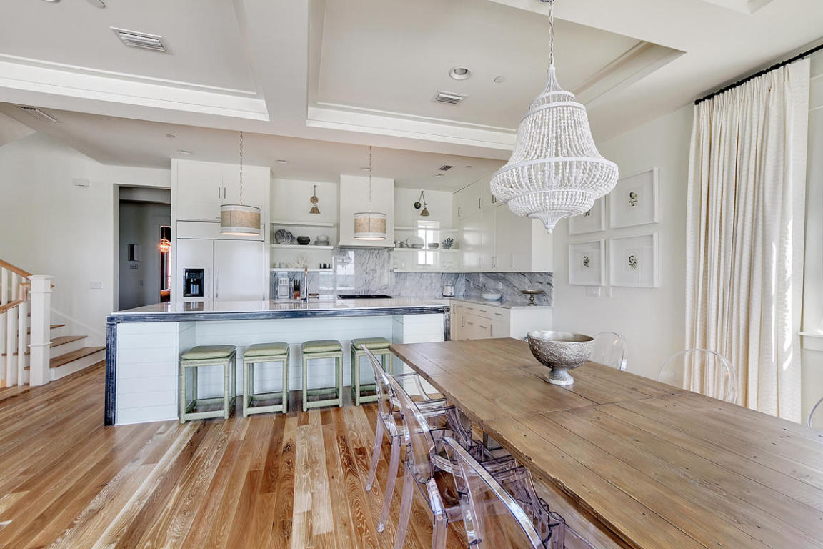 7 Winston Ln Inlet Beach Inlet Beach, FL 32461 - Photo 8 of 19 a kitchen with stainless steel appliances a table chairs in it and wooden floors
