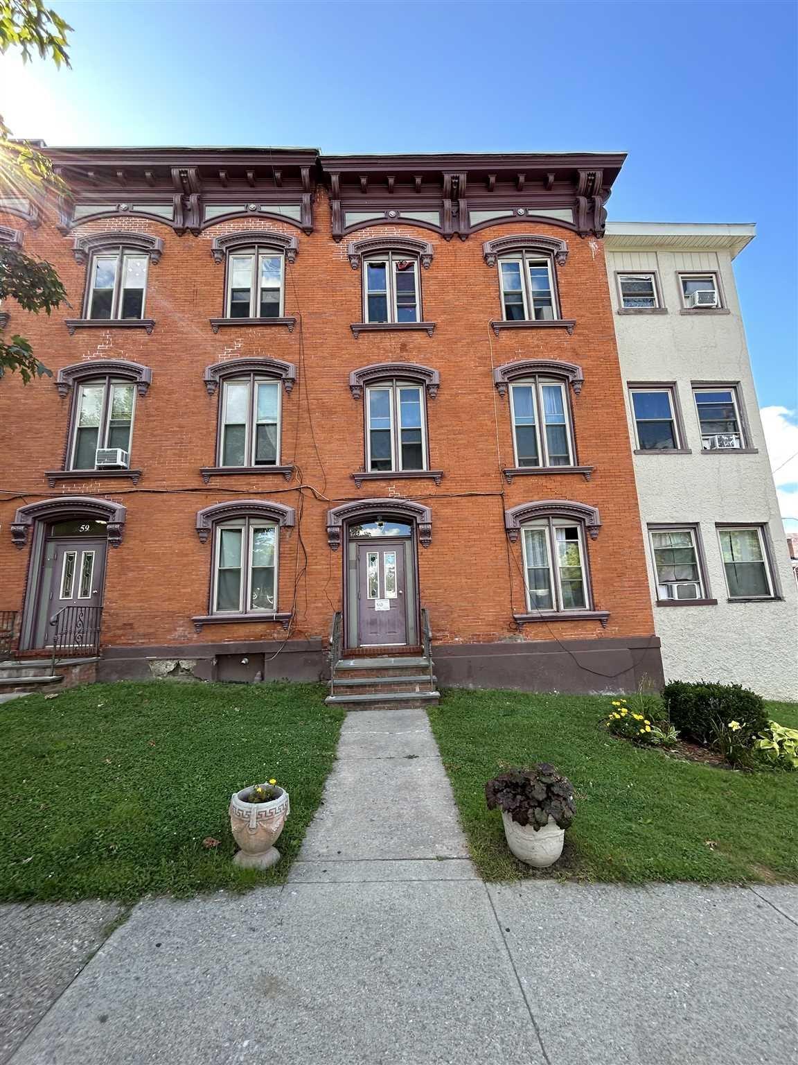 57 South Hamilton Street, Unit 4 Poughkeepsie, NY 12601 - Photo 1 of 1 front view of a brick house with a yard