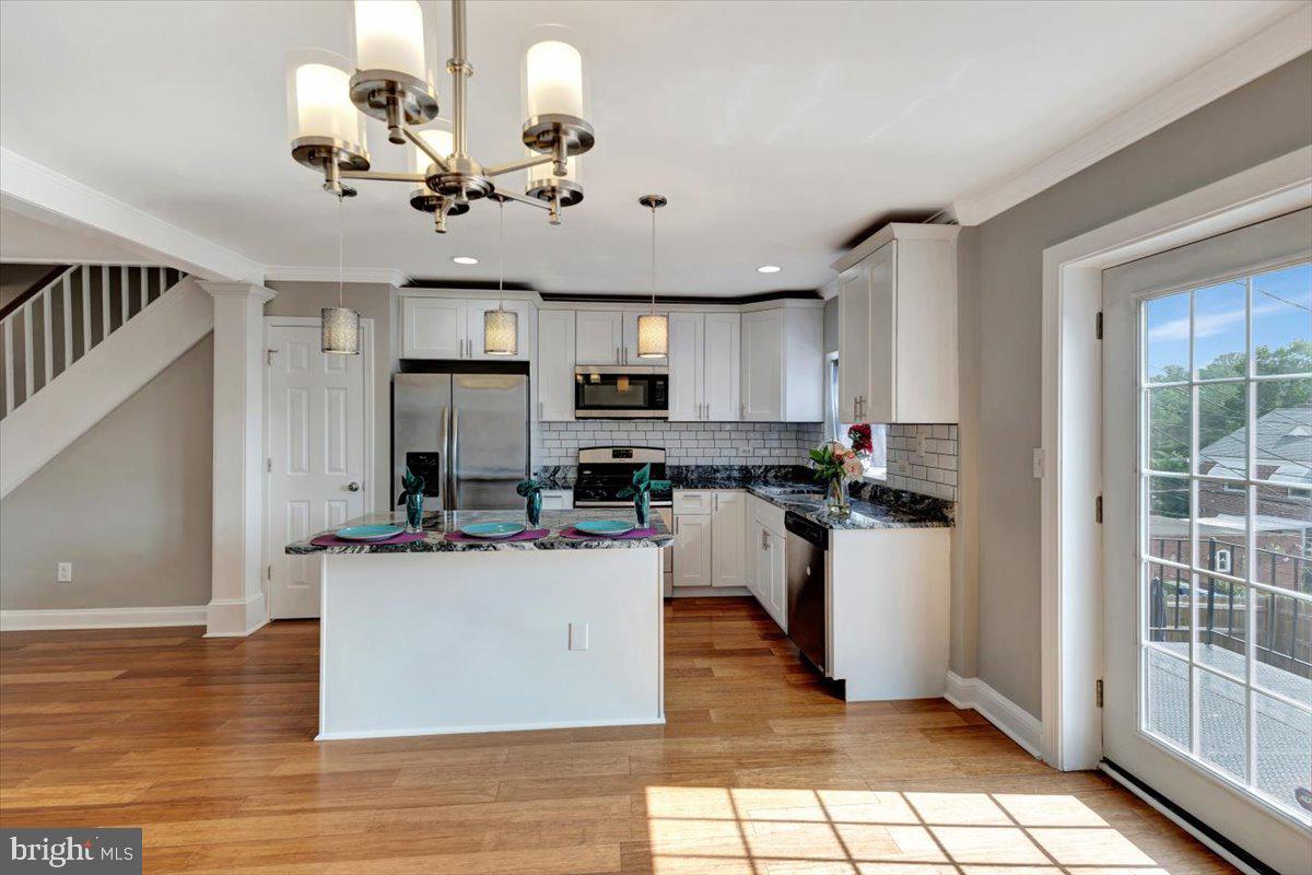 3927 Yolando Road Baltimore, MD 21218 - Photo 11 of 50 a view of a kitchen with kitchen island stainless steel appliances refrigerator stove microwave and cabinets
