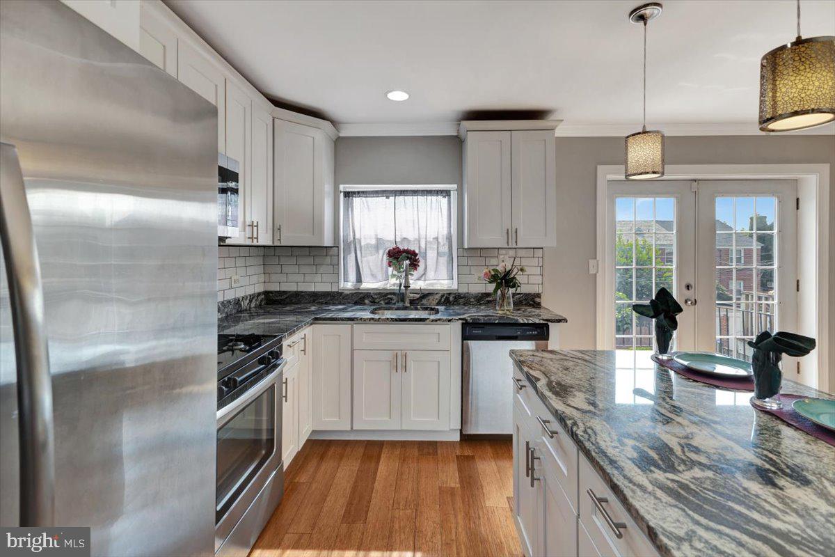 3927 Yolando Road Baltimore, MD 21218 - Photo 14 of 50 a kitchen with stainless steel appliances granite countertop a sink stove and refrigerator