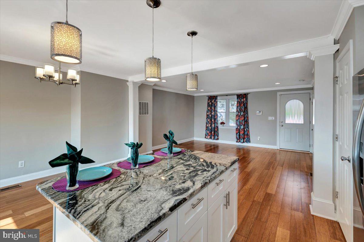 3927 Yolando Road Baltimore, MD 21218 - Photo 15 of 50 a living room with kitchen island furniture and a wooden floor