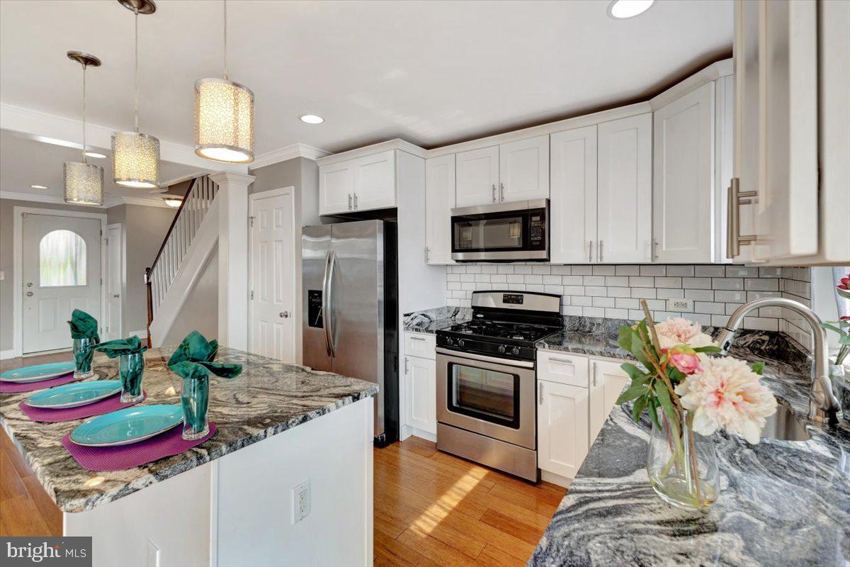 3927 Yolando Road Baltimore, MD 21218 - Photo 16 of 50 a kitchen with granite countertop a sink appliances and cabinets