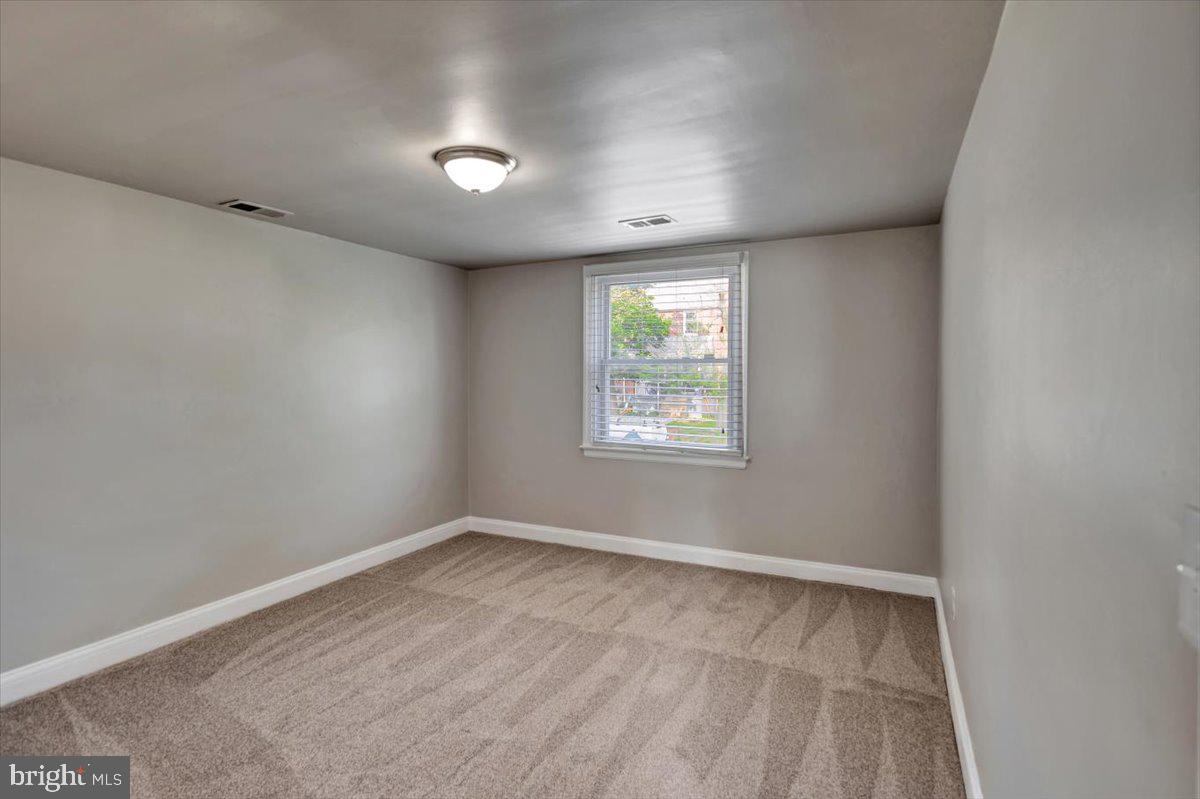 3927 Yolando Road Baltimore, MD 21218 - Photo 23 of 50 an empty room with windows