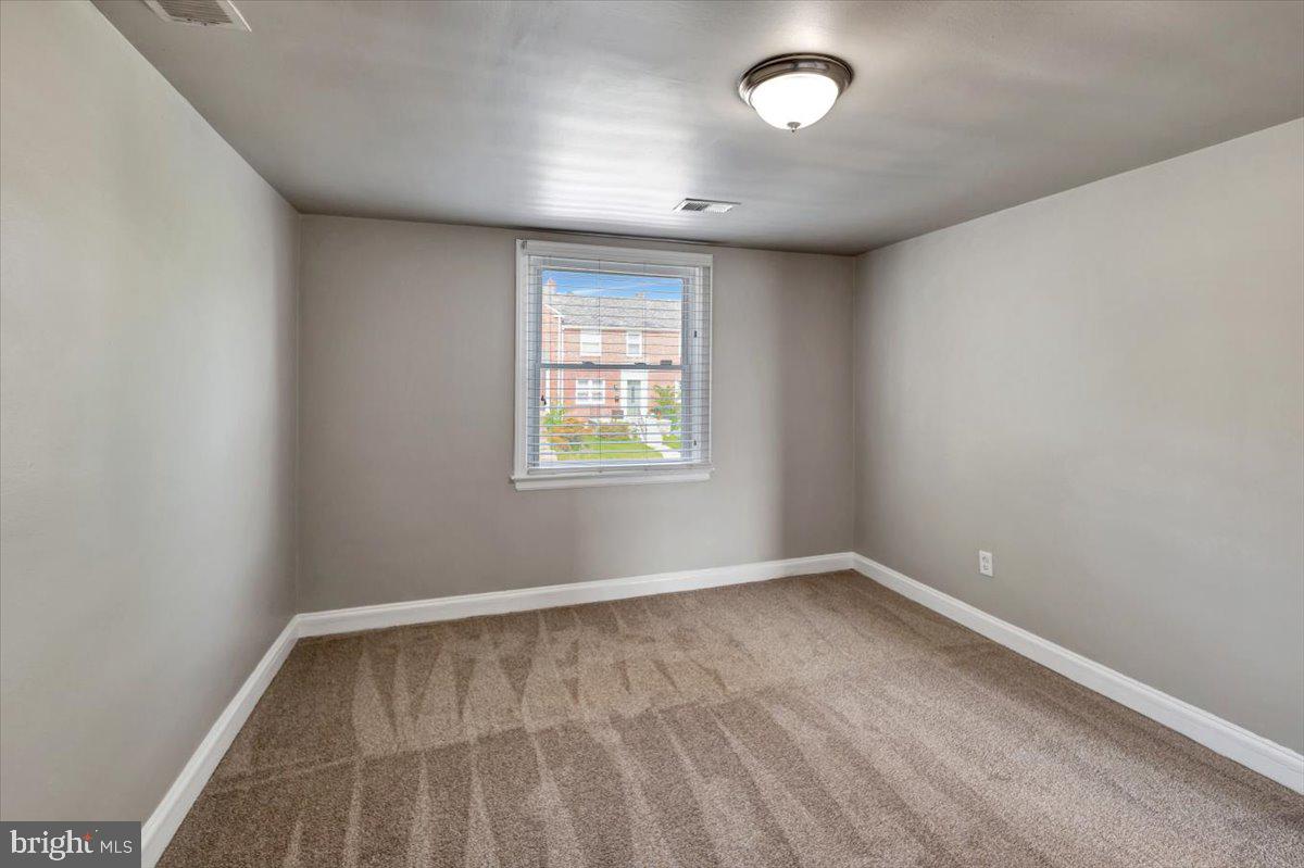 3927 Yolando Road Baltimore, MD 21218 - Photo 27 of 50 an empty room with a empty space and windows