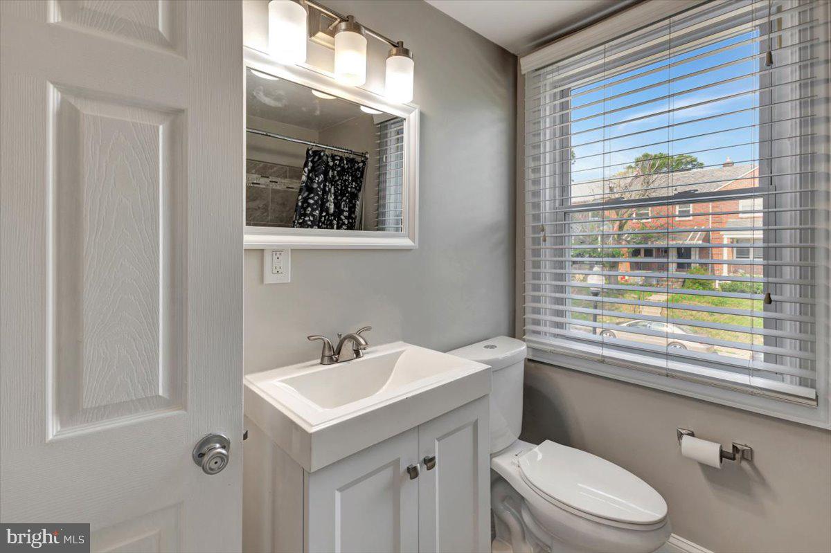 3927 Yolando Road Baltimore, MD 21218 - Photo 28 of 50 a bathroom with a sink a mirror and a toilet