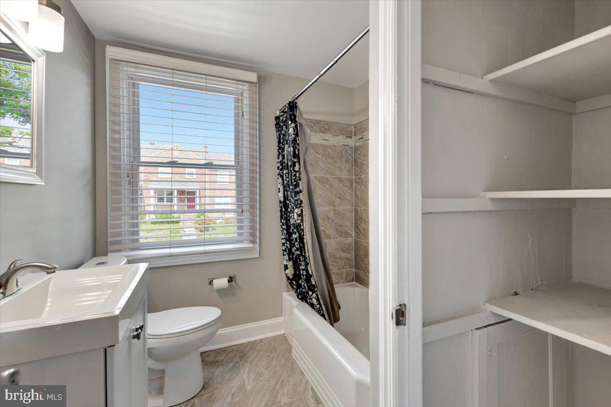 3927 Yolando Road Baltimore, MD 21218 - Photo 30 of 50 a bathroom with a toilet a sink and a window