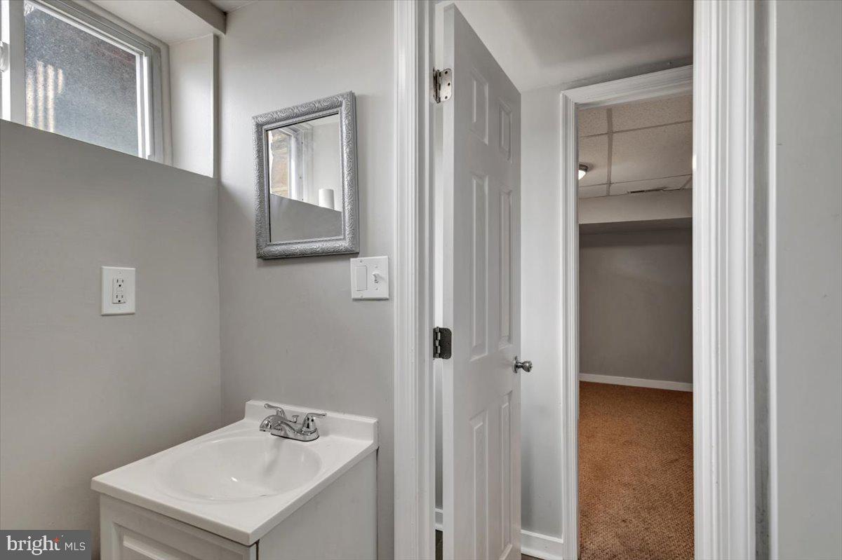 3927 Yolando Road Baltimore, MD 21218 - Photo 35 of 50 a bathroom with a sink and mirror