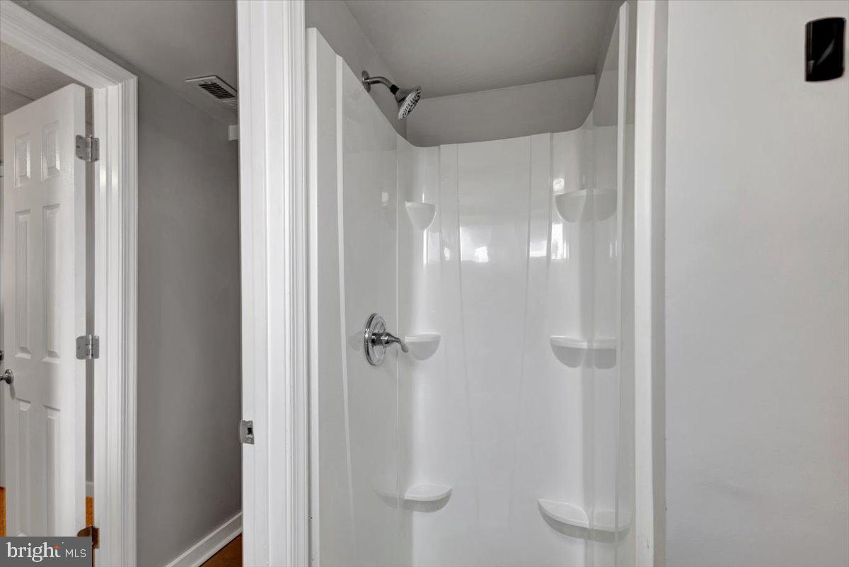 3927 Yolando Road Baltimore, MD 21218 - Photo 36 of 50 a bathroom with a glass shower door