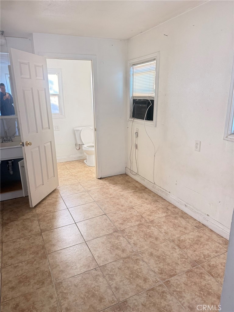 3881 Eucalyptus Avenue, Unit 3 Riverside, CA 92507 - Photo 2 of 5 an empty room with a fireplace and mirror