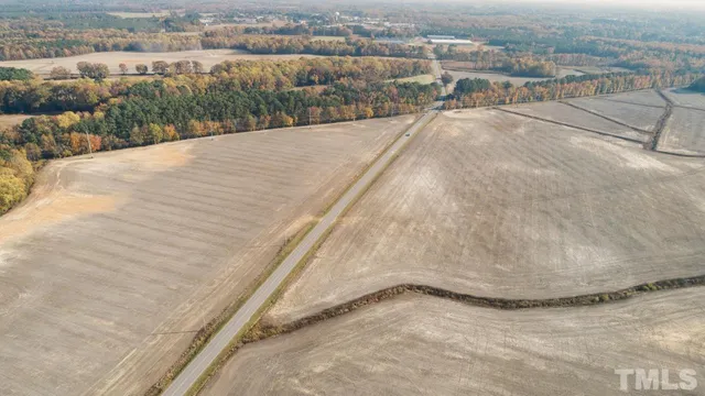 a view of a dry yard with a barn