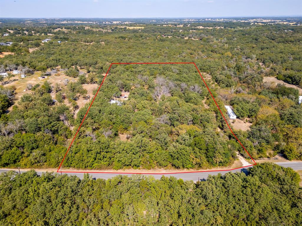 436 Luke Road Springtown, TX 76082 - Photo 34 of 39 Aerial overview of property's location with property parcel outlined and a forest