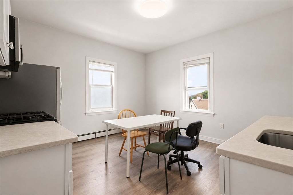 39 Union Street Boston, MA 02135 - Photo 11 of 33 a workspace with furniture and window