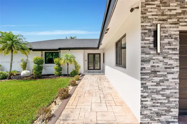 a front view of a house with garden