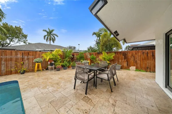 a view of a house with backyard and sitting area