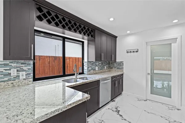 a kitchen with granite countertop cabinets stainless steel appliances and a counter space