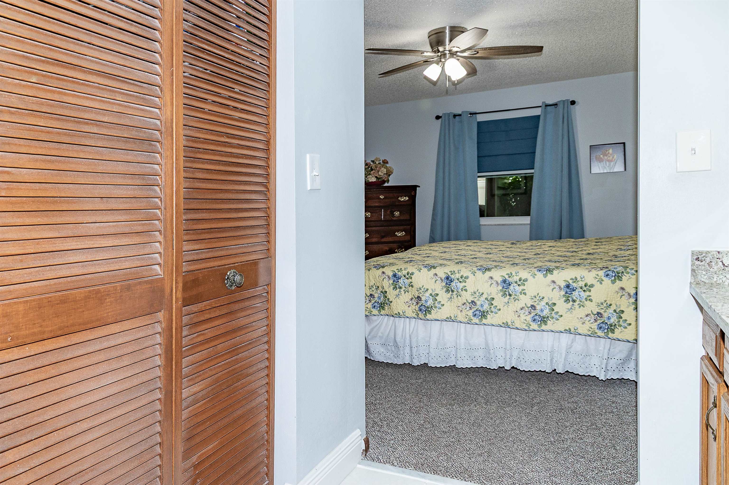 357 Orchis Road St. Augustine, FL 32086 - Photo 35 of 54 a bedroom with a bed and a chandelier