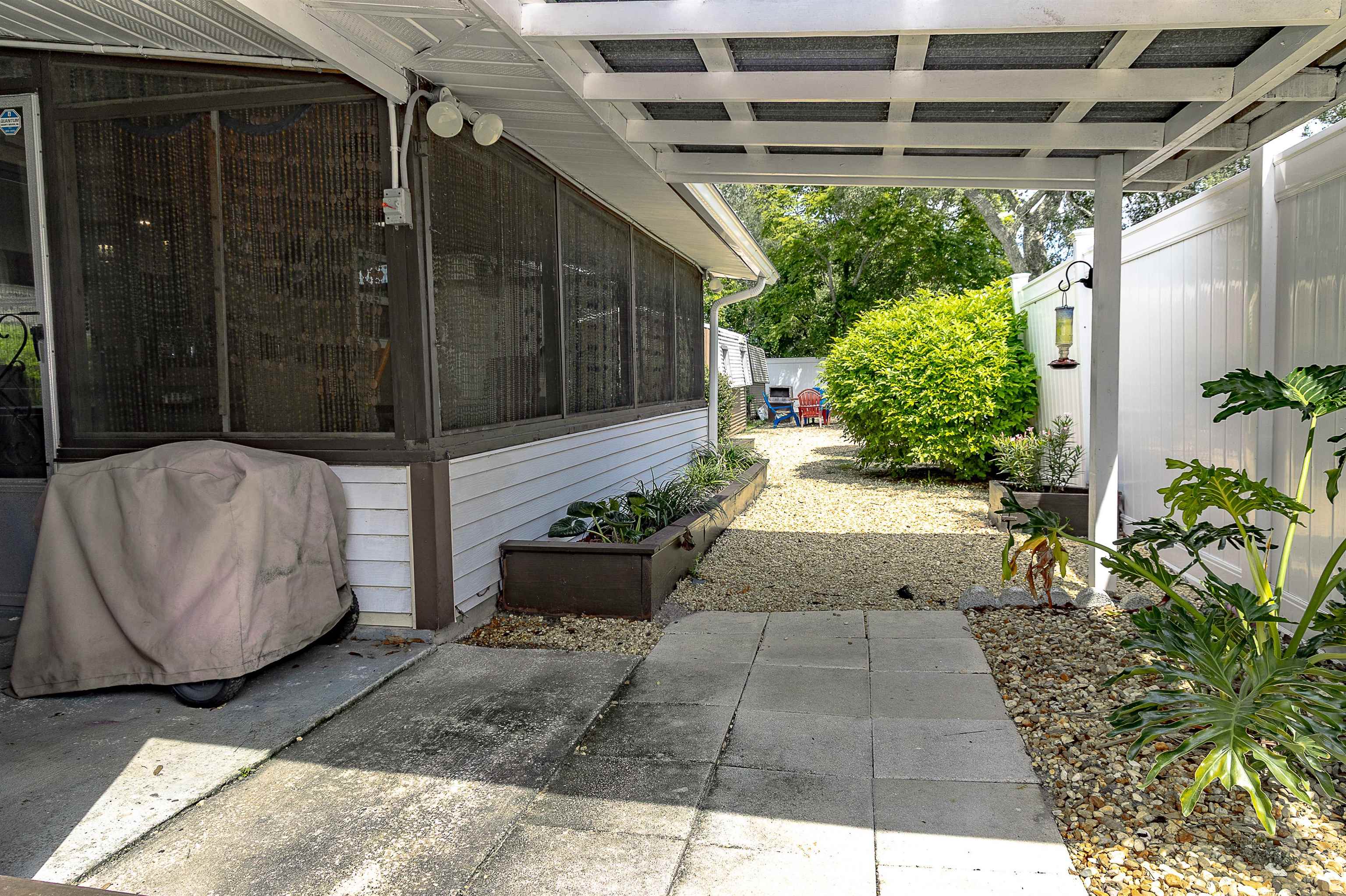357 Orchis Road St. Augustine, FL 32086 - Photo 47 of 54 a view of a porch with potted plants