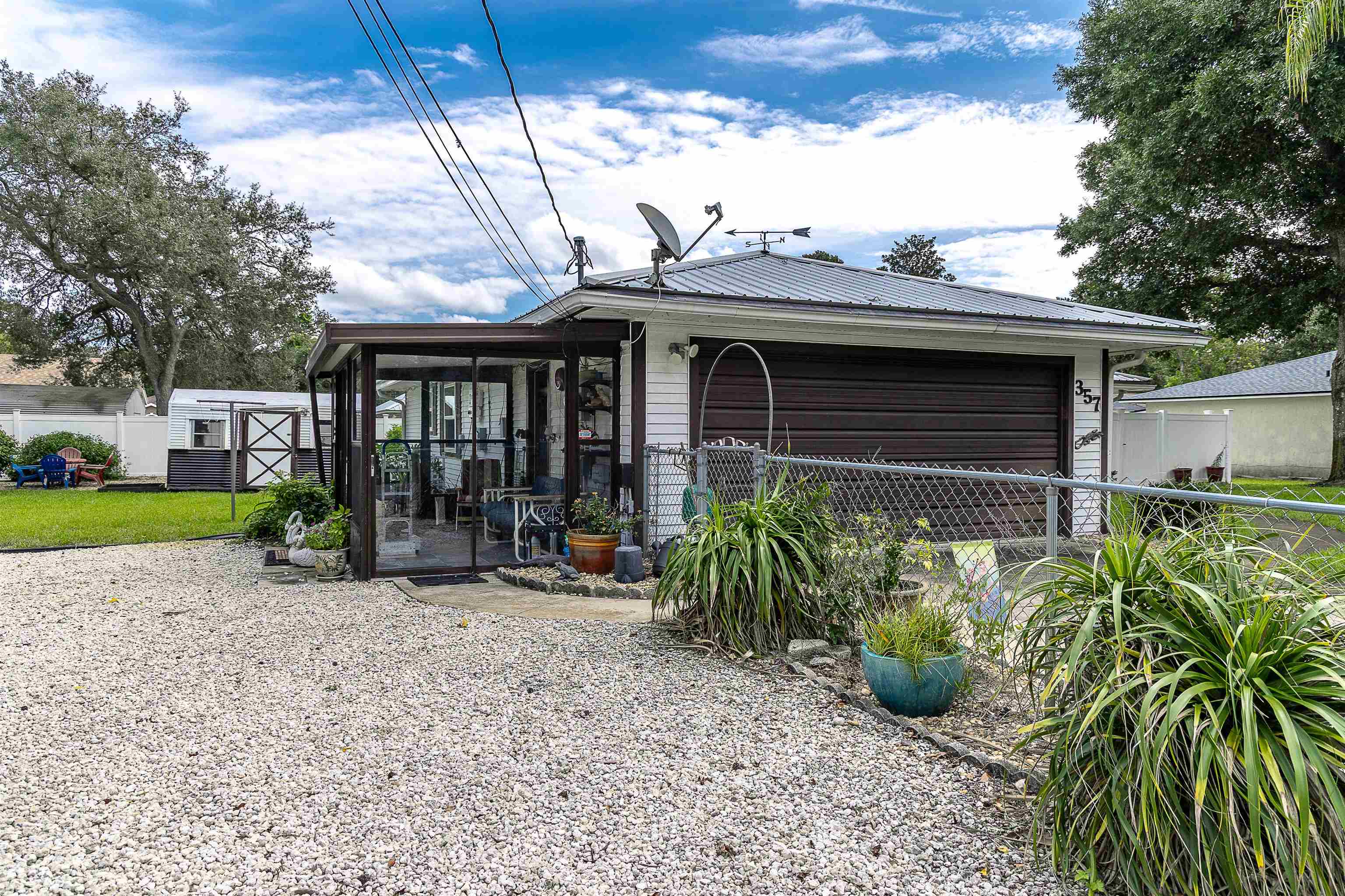 357 Orchis Road St. Augustine, FL 32086 - Photo 5 of 54 a view of a chair and table in the garden
