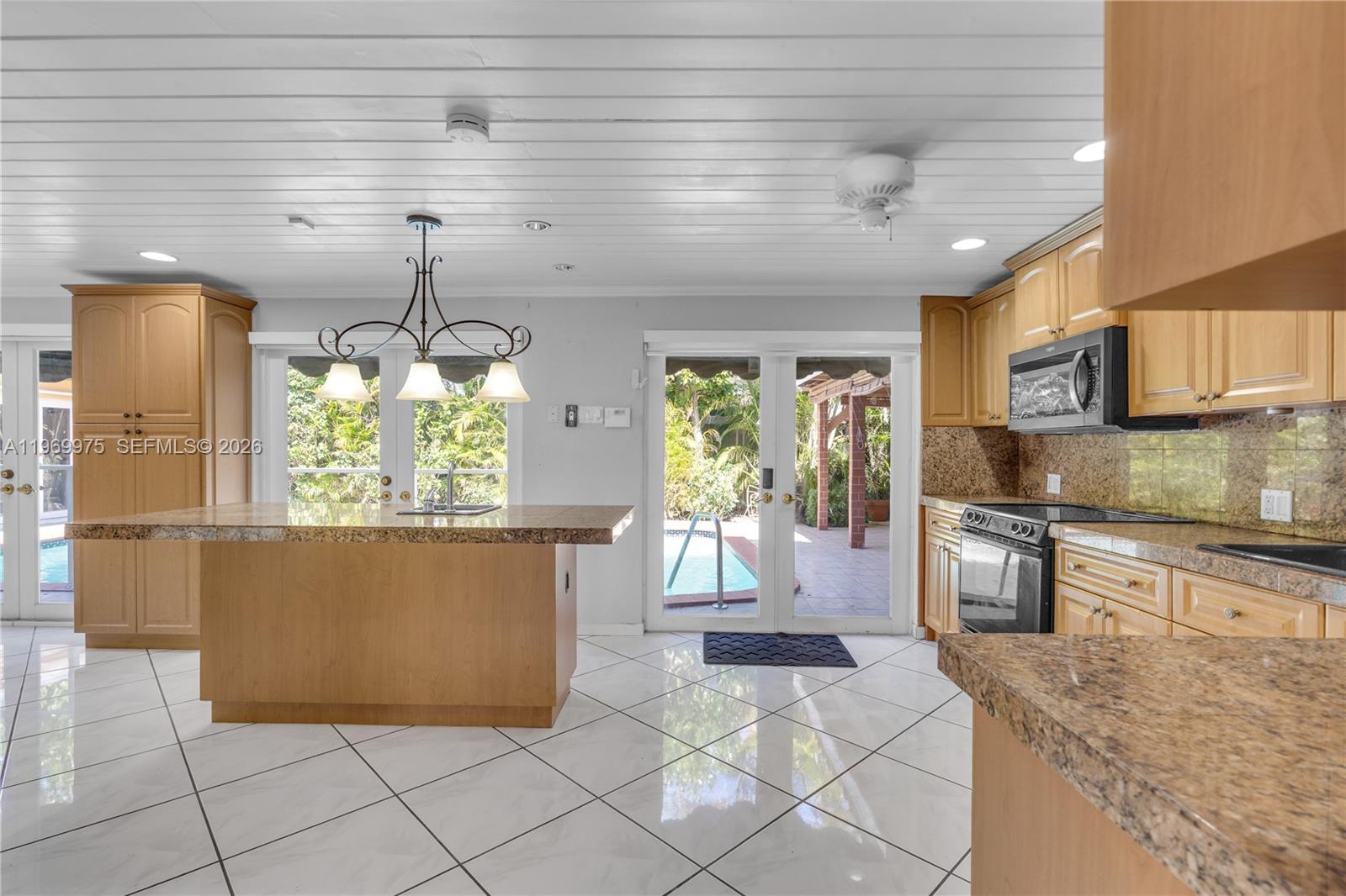 7941 Southwest 18th Terrace Miami, FL 33155 - Photo 17 of 60 a kitchen with stainless steel appliances granite countertop a stove and refrigerator