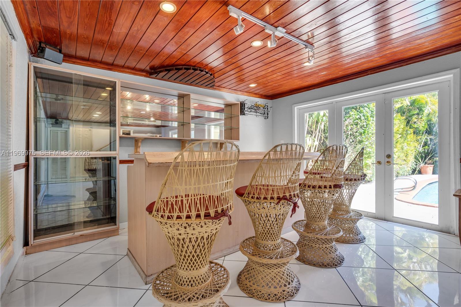 7941 Southwest 18th Terrace Miami, FL 33155 - Photo 21 of 60 a dining room with furniture large windows and wooden floor