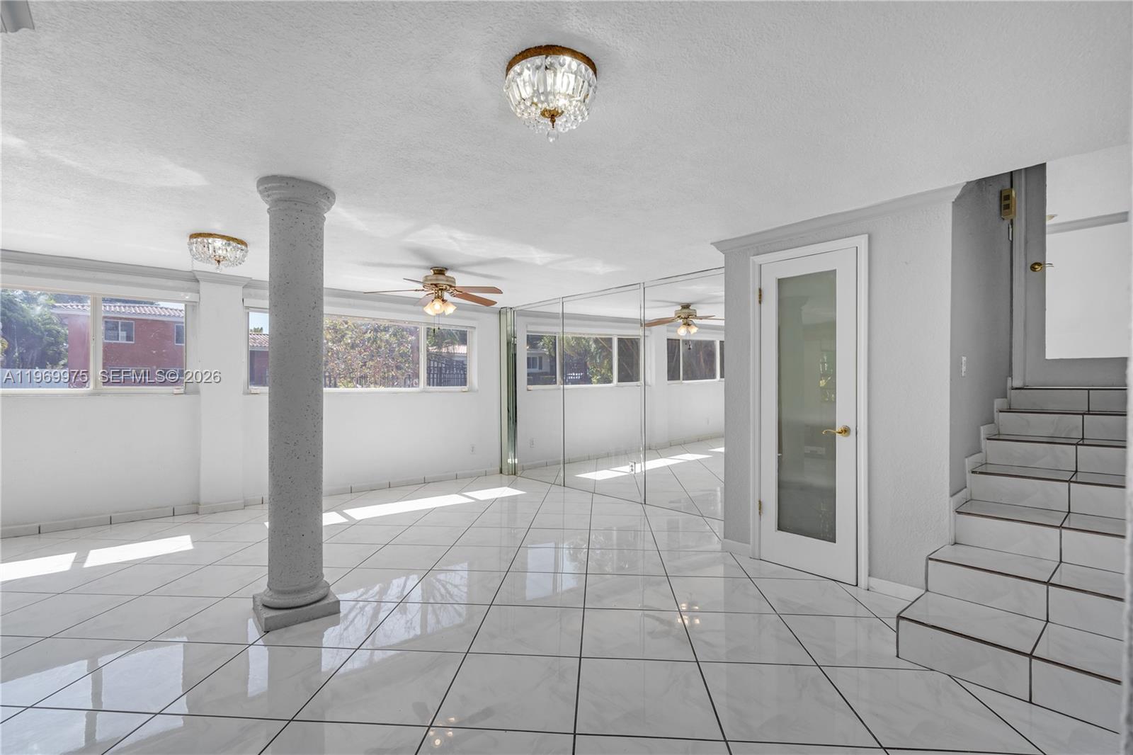 7941 Southwest 18th Terrace Miami, FL 33155 - Photo 25 of 60 a view of a hallway with wooden floor and a living room