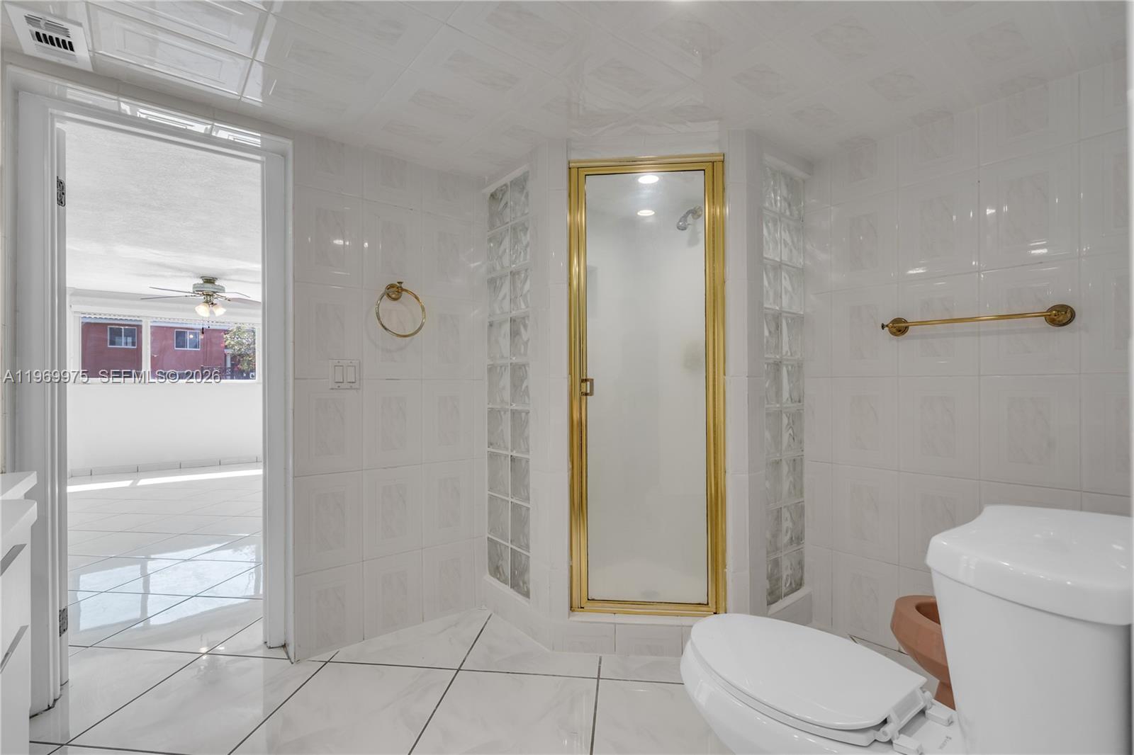 7941 Southwest 18th Terrace Miami, FL 33155 - Photo 30 of 60 a bathroom with a toilet and a shower