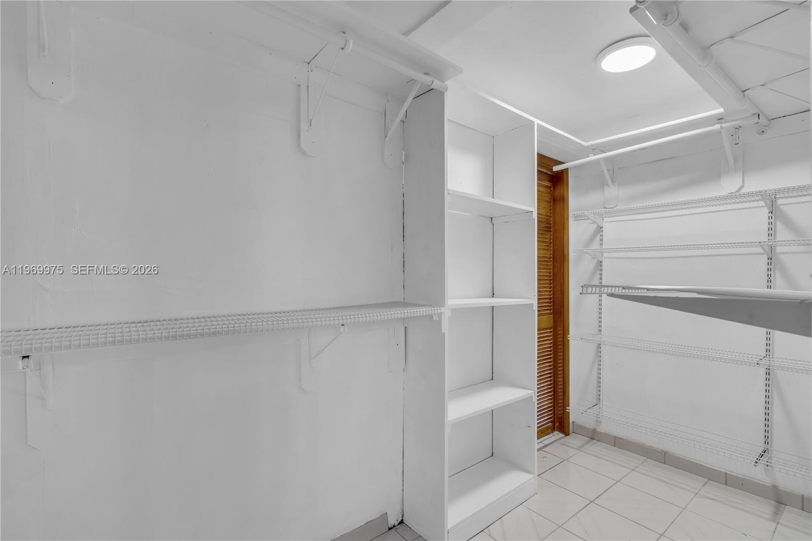 7941 Southwest 18th Terrace Miami, FL 33155 - Photo 36 of 60 a view of walk in closet with empty racks