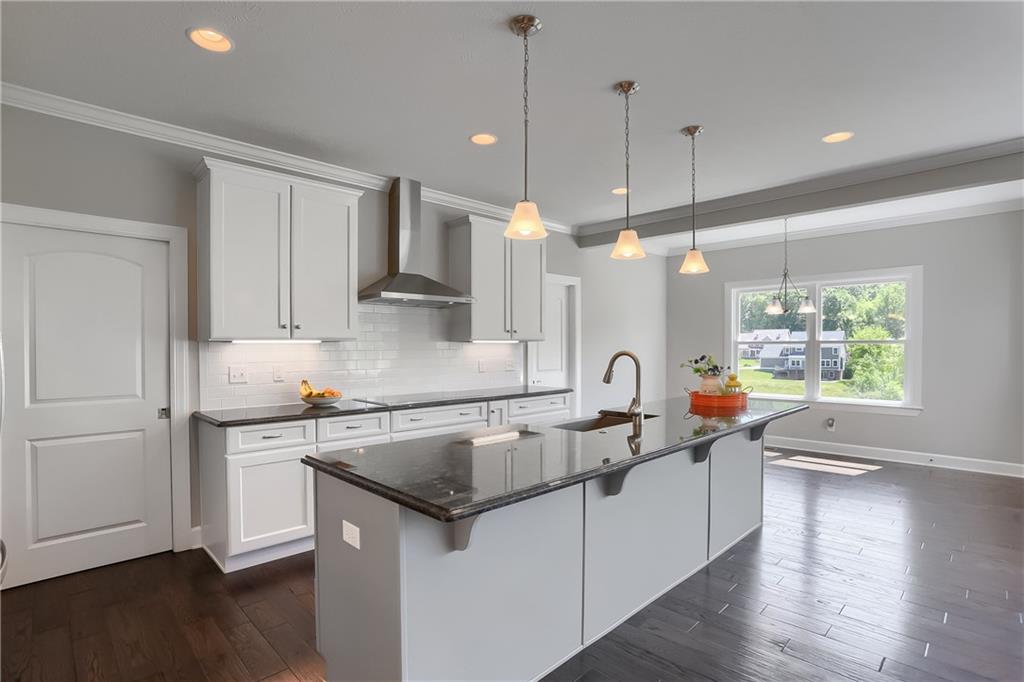 237 Tamarack Drive Gibsonia, PA 15044 - Photo 14 of 48 a kitchen with stainless steel appliances granite countertop a sink a stove and a wooden floors