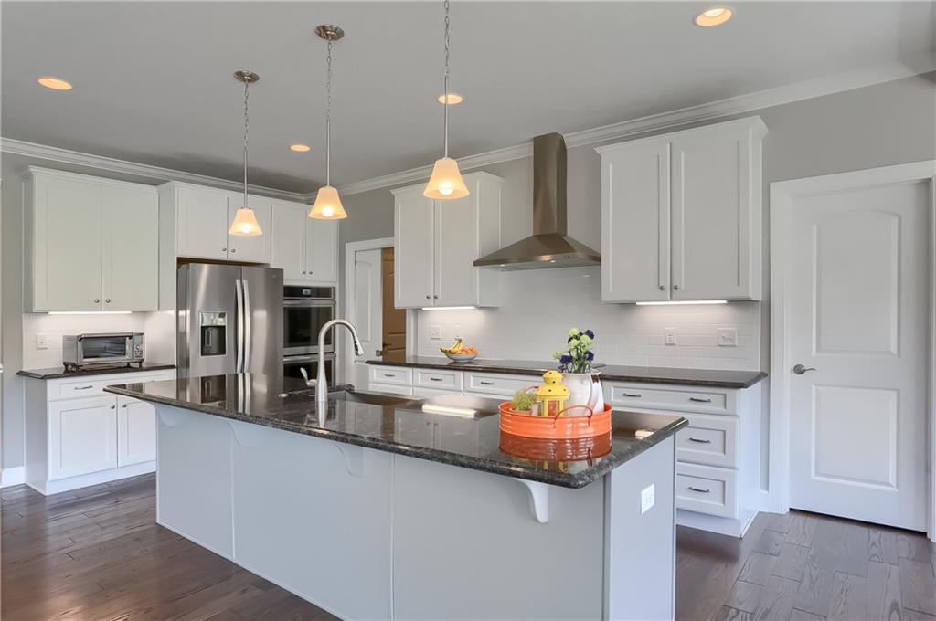 237 Tamarack Drive Gibsonia, PA 15044 - Photo 15 of 48 a kitchen with kitchen island granite countertop a sink stainless steel appliances and white cabinets