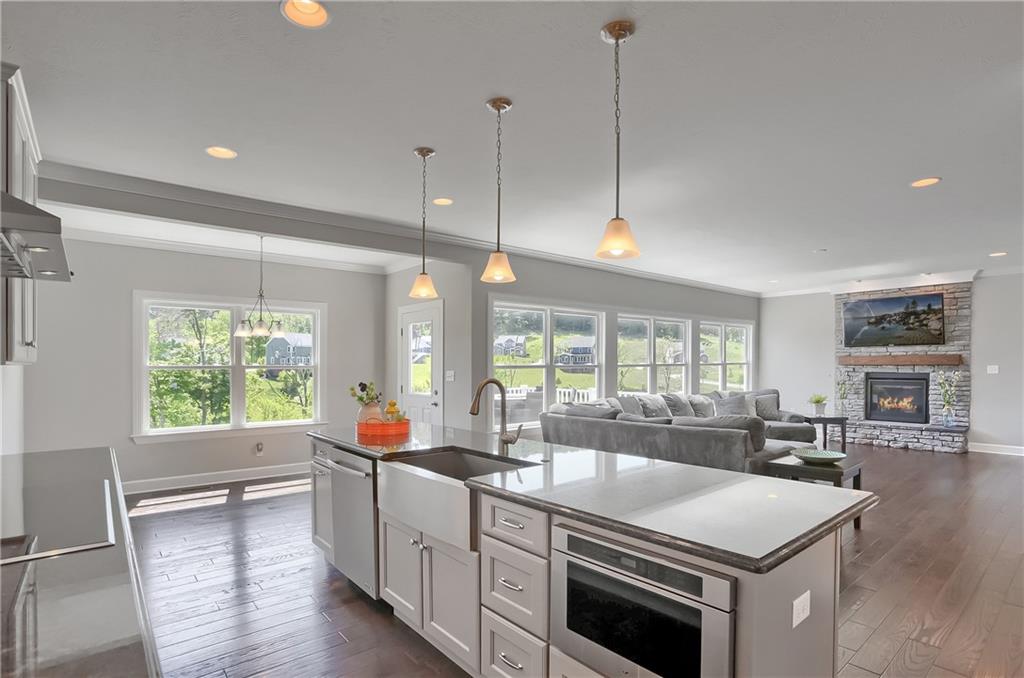 237 Tamarack Drive Gibsonia, PA 15044 - Photo 18 of 48 a kitchen with stainless steel appliances granite countertop a stove a sink and a refrigerator with wooden floor
