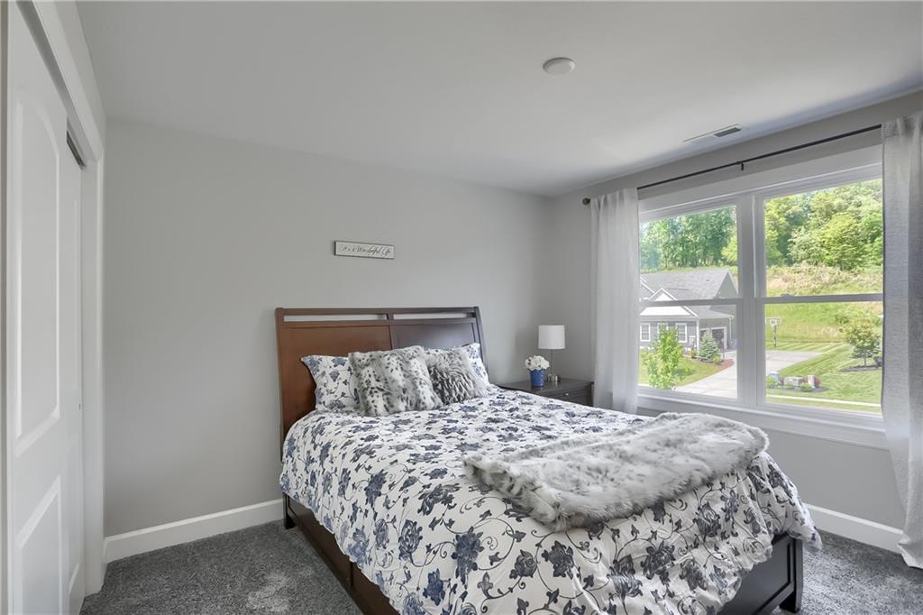 237 Tamarack Drive Gibsonia, PA 15044 - Photo 28 of 48 a bedroom with a large bed and a window