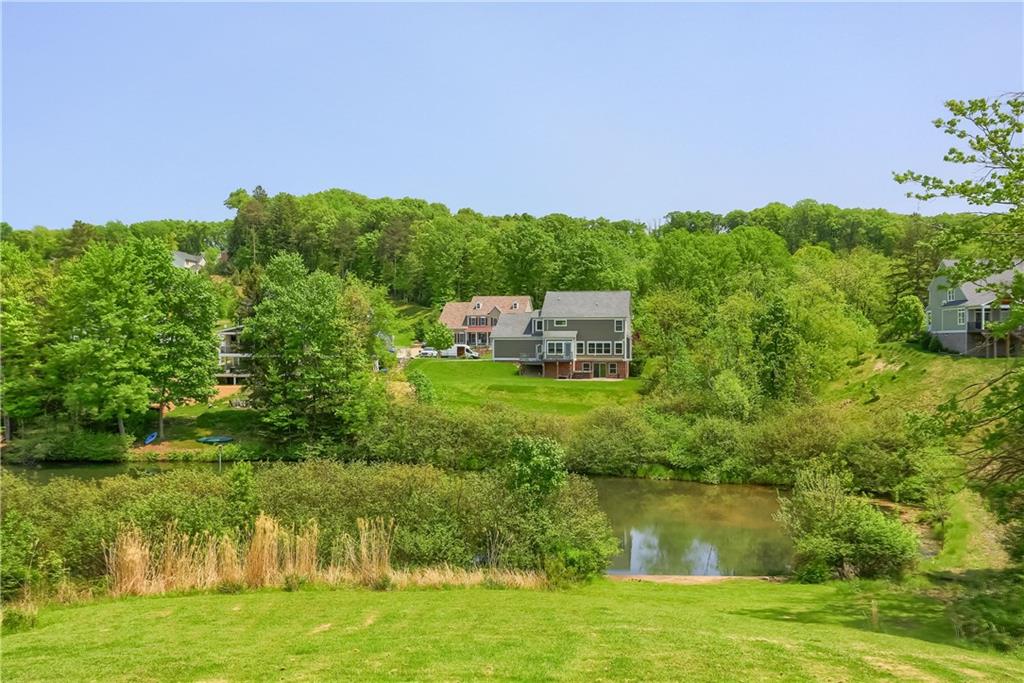 237 Tamarack Drive Gibsonia, PA 15044 - Photo 46 of 48 a view of a lake with a house in the background