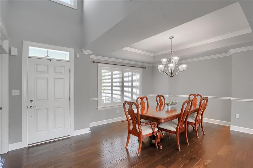 237 Tamarack Drive Gibsonia, PA 15044 - Photo 6 of 48 a view of a dining room with furniture a chandelier and wooden floor