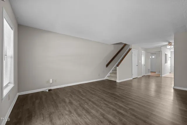 wooden floor in an empty room with a kitchen